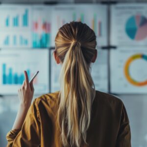 a woman looking at a board with data