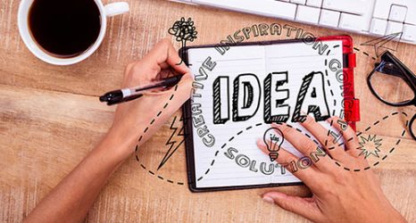 digital composite of hands using notebook with graphics